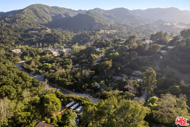 a view of a mountain range with lush green forest