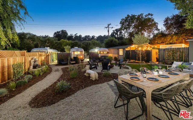 a view of backyard with patio and outdoor seating