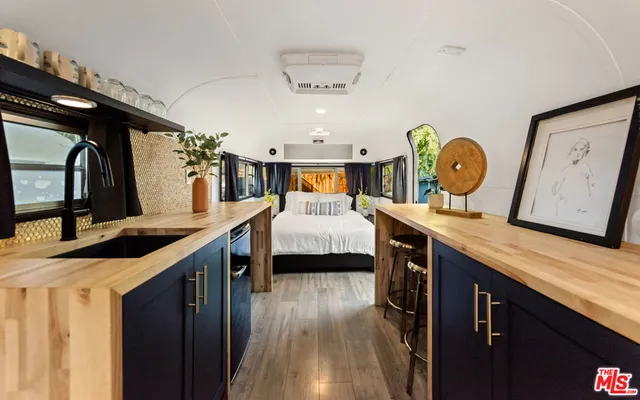 a view of a kitchen area with furniture and wooden floor