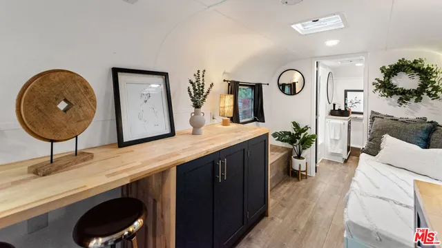 a living room with furniture and a mirror