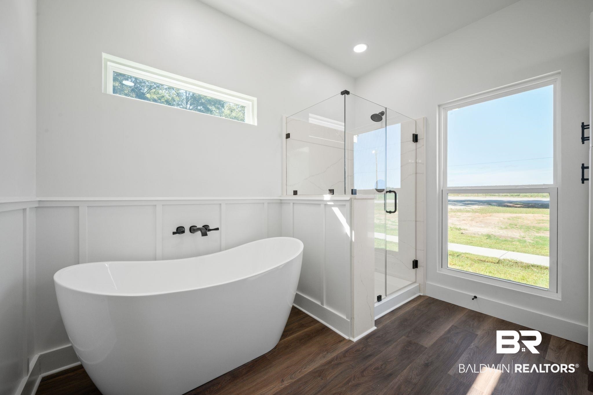 12100 Lott Road Chunchula, AL 36521 - Photo 10 of 21 Bathroom with separate shower and tub, a healthy amount of sunlight, and wood-type flooring