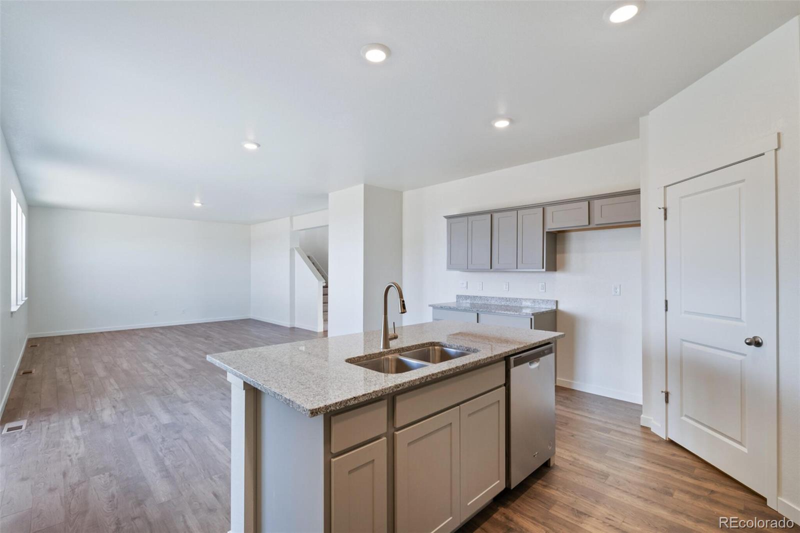 6020 Amerifax Drive Windsor, CO 80528 - Photo 7 of 16 a kitchen with a sink cabinets and wooden floor