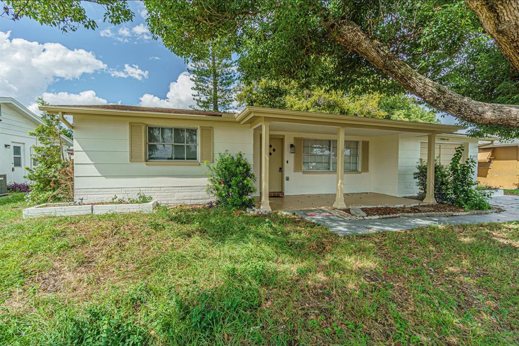 5631 Riddle Road Holiday, FL 34690 - Photo 1 of 27 front view of house with a yard and trees all around