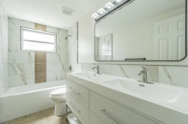 a bathroom with a bathtub and window