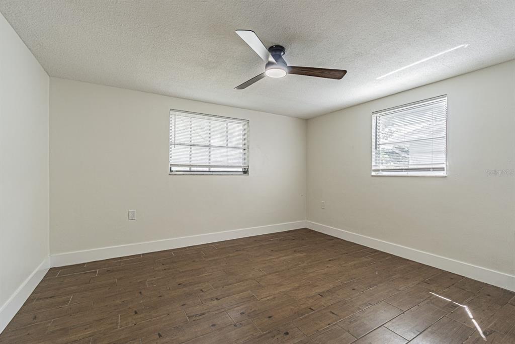 5631 Riddle Road Holiday, FL 34690 - Photo 19 of 27 a view of an empty room with wooden floor and a window