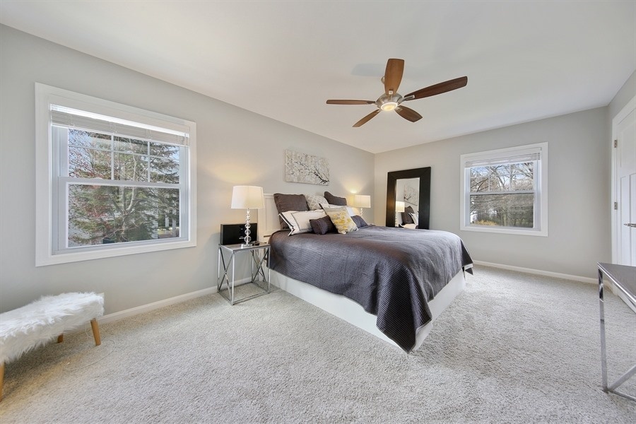 906 South County Line Road Hinsdale, IL 60521 - Photo 20 of 44 a spacious bedroom with a large bed and a window