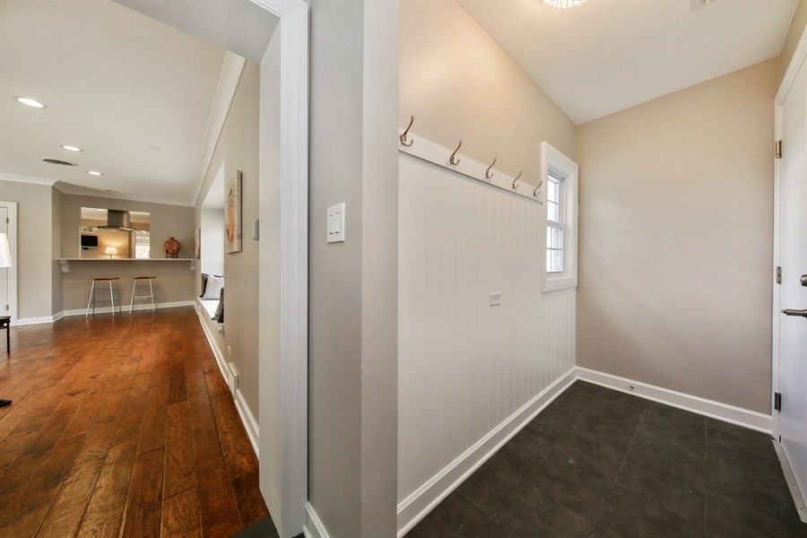 906 South County Line Road Hinsdale, IL 60521 - Photo 31 of 44 a view of a hallway with wooden floor and a kitchen