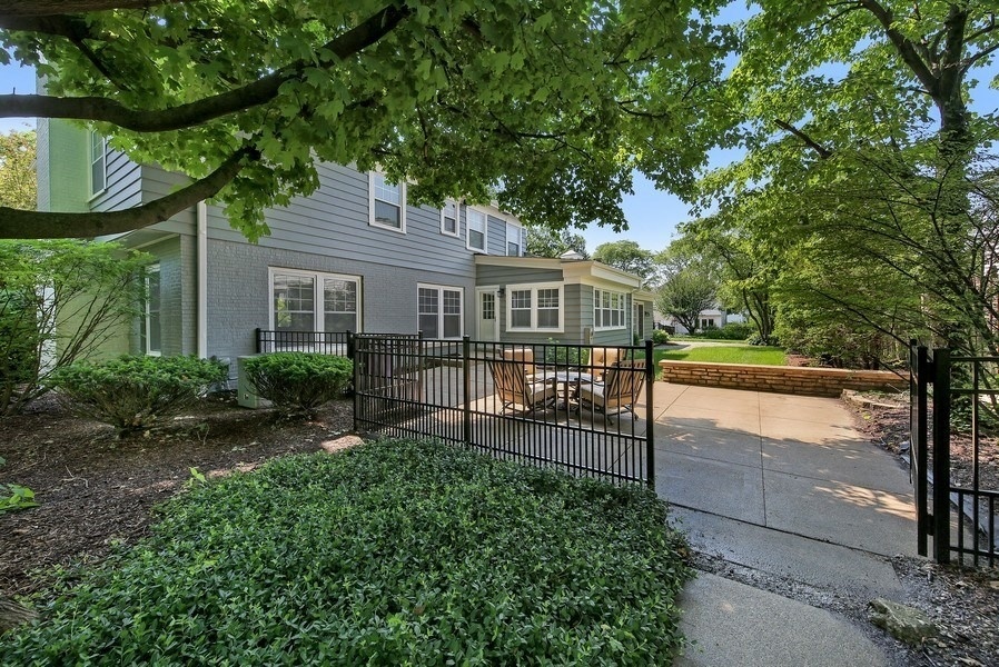 906 South County Line Road Hinsdale, IL 60521 - Photo 33 of 44 a view of a house with a small yard and a large tree