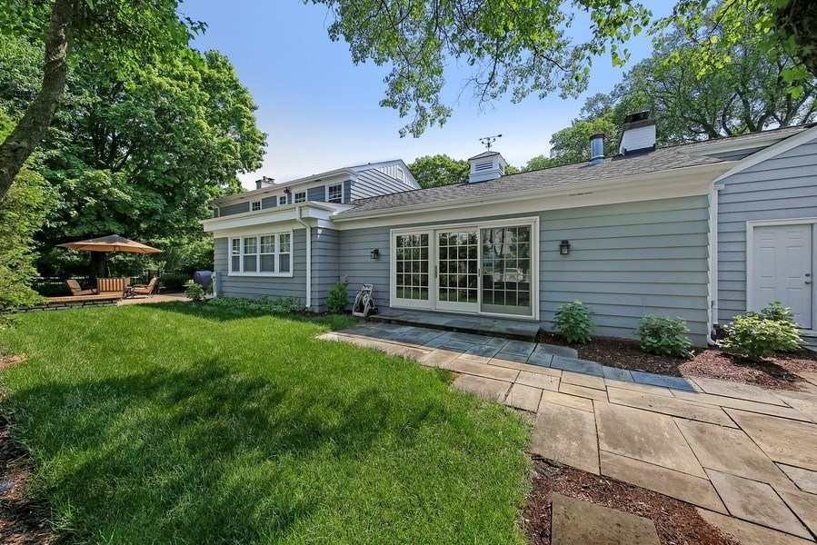 906 South County Line Road Hinsdale, IL 60521 - Photo 37 of 44 a front view of a house with a yard and outdoor seating