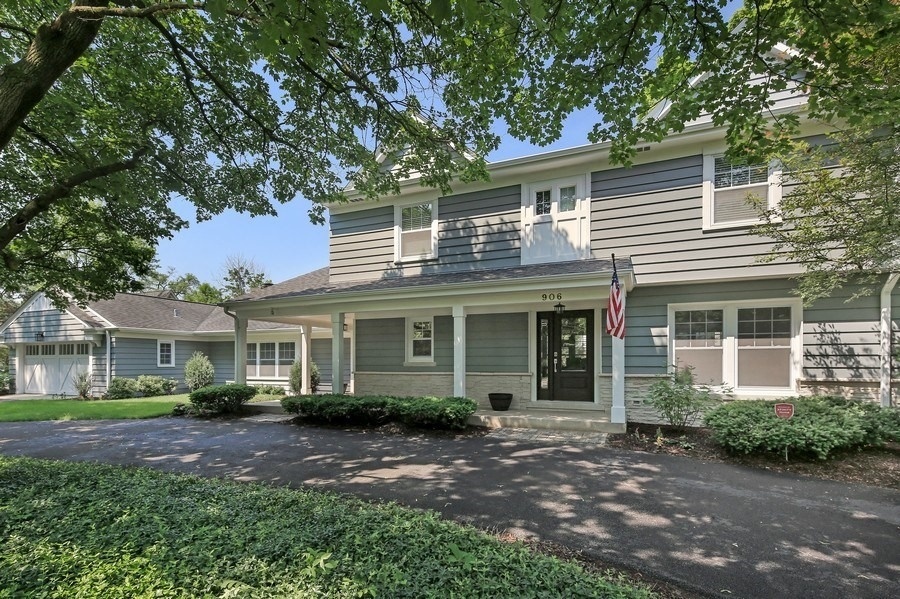 906 South County Line Road Hinsdale, IL 60521 - Photo 44 of 44 a front view of a house with a yard and potted plants