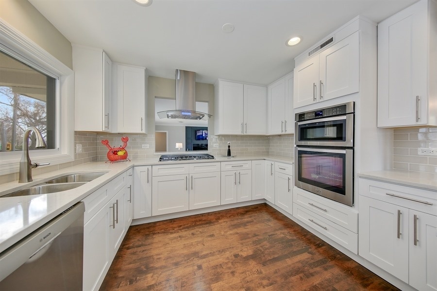 906 South County Line Road Hinsdale, IL 60521 - Photo 7 of 44 a kitchen with stainless steel appliances granite countertop a sink and cabinets