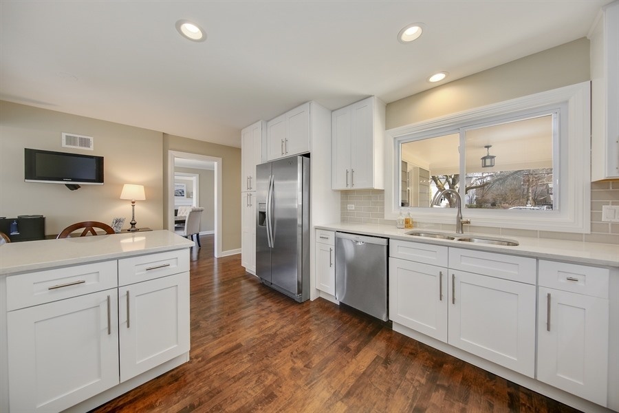 906 South County Line Road Hinsdale, IL 60521 - Photo 8 of 44 a kitchen with white cabinets and stainless steel appliances