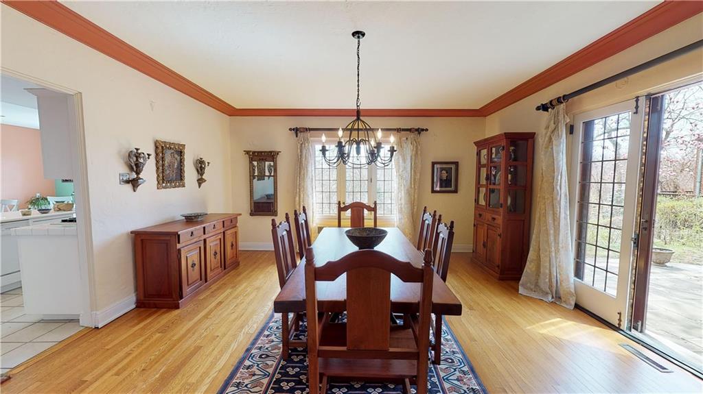5426 Darlington Road Pittsburgh, PA 15217 - Photo 9 of 24 a dining room with furniture a chandelier and wooden floor
