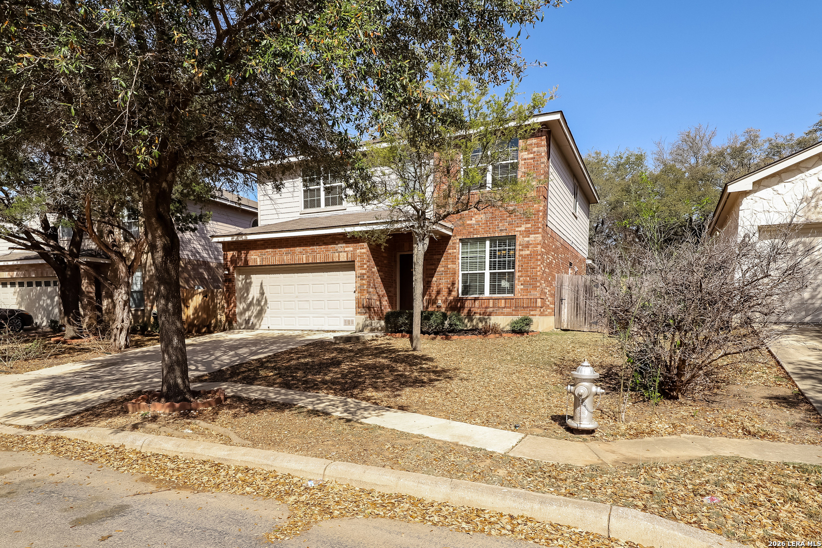 8611 Tioga Pass Helotes, TX 78023 - Photo 1 of 14 a front view of a house with a yard
