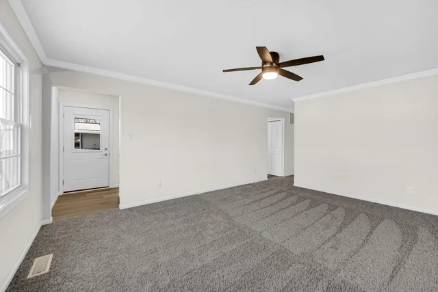 a view of empty room with ceiling fan