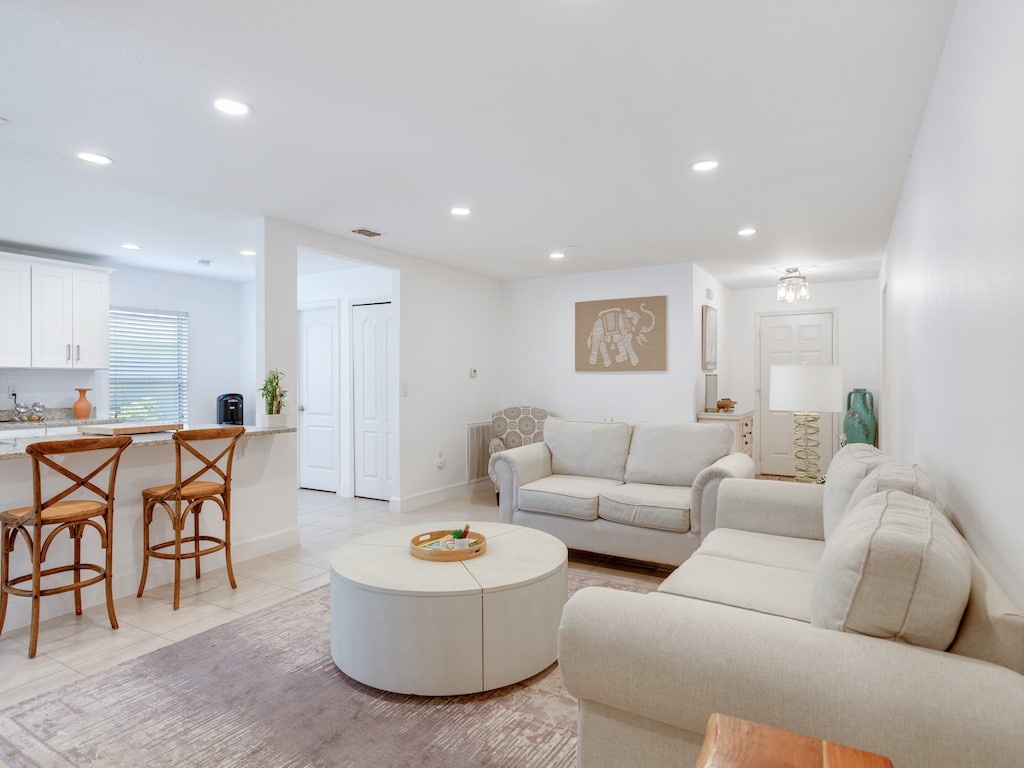 402 Lexington Avenue Southwest Vero Beach, FL 32962 - Photo 1 of 33 a living room with furniture and a dining table with kitchen view