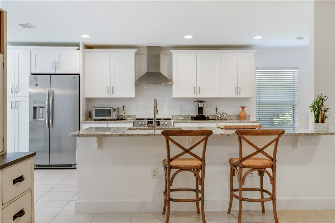 402 Lexington Avenue Southwest Vero Beach, FL 32962 - Photo 12 of 33 a kitchen with stainless steel appliances granite countertop a stove a sink and a refrigerator