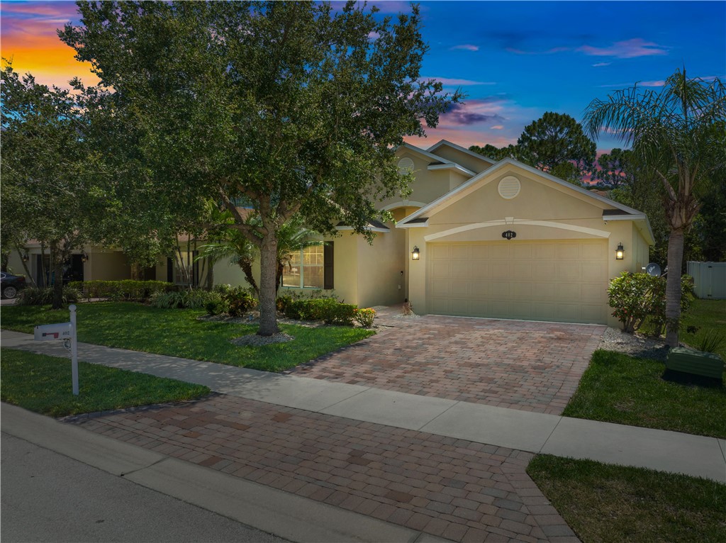 402 Lexington Avenue Southwest Vero Beach, FL 32962 - Photo 2 of 33 a front view of a house with a yard and garage