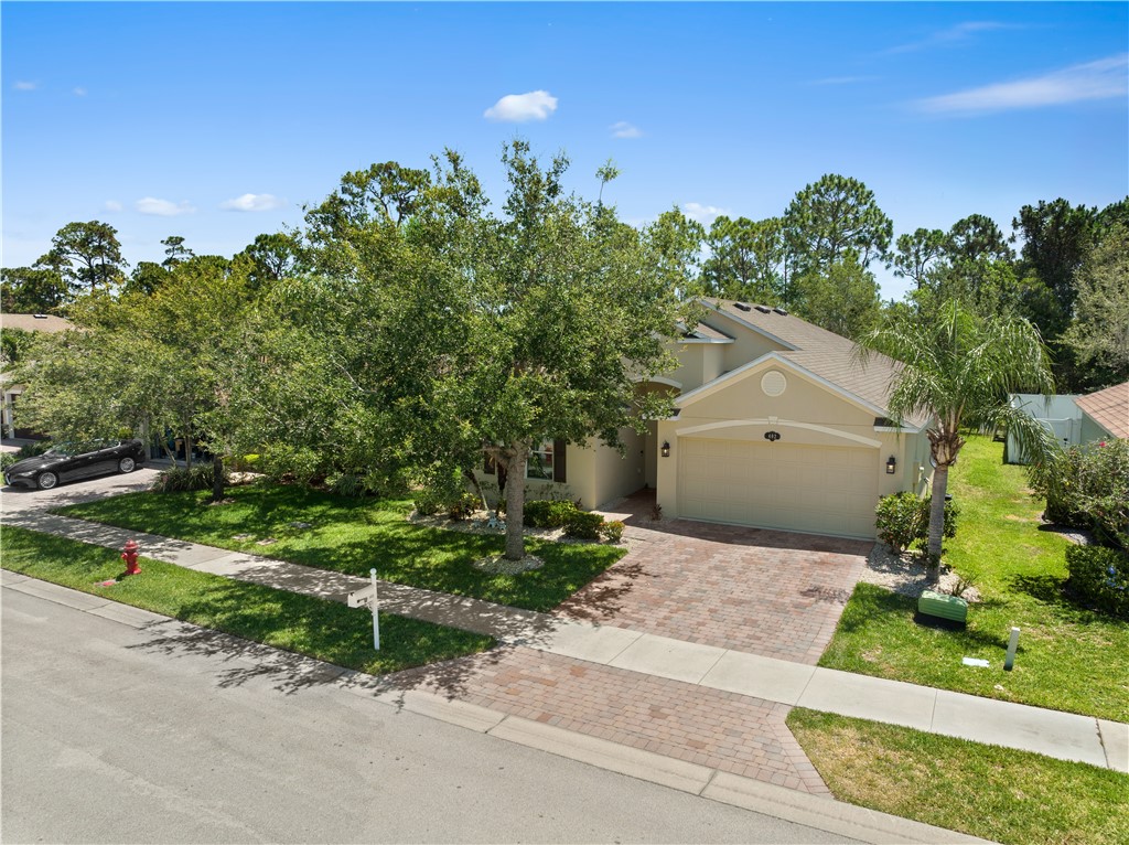 402 Lexington Avenue Southwest Vero Beach, FL 32962 - Photo 3 of 33 a front view of a house with a yard and garage