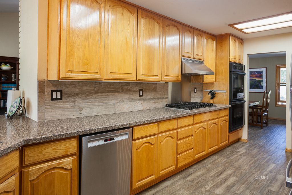 400 Dominy Road Lone Pine, CA 93545 - Photo 5 of 33 a kitchen with stainless steel appliances granite countertop a sink and cabinets