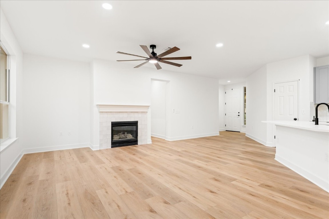 151 Dan Moody Trail Georgetown, TX 78633 - Photo 12 of 31 a view of a livingroom with a fireplace a ceiling fan and wooden floor