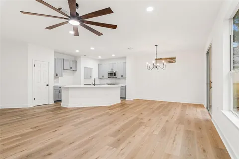 a view of kitchen with granite countertop cabinets and refrigerator
