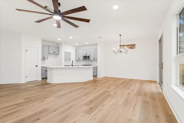 a view of kitchen with granite countertop cabinets and refrigerator