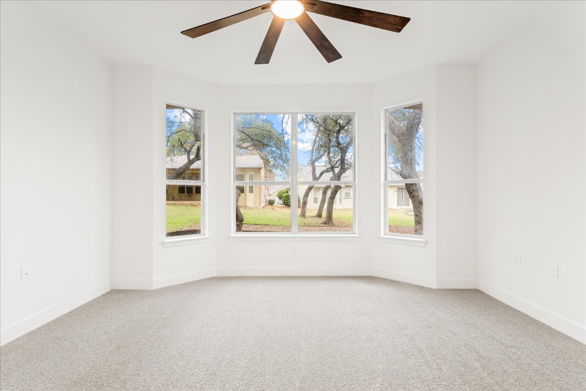 151 Dan Moody Trail Georgetown, TX 78633 - Photo 20 of 31 an empty room with windows and chandelier fan