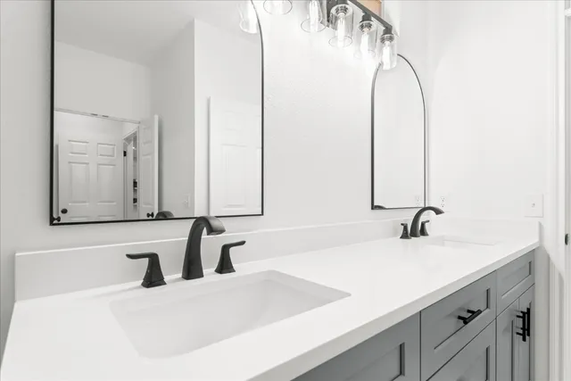 a bathroom with a double vanity sink and a mirror
