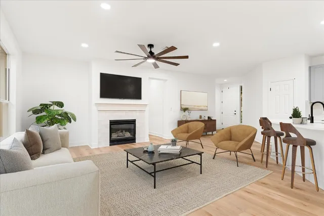 a living room with furniture a fireplace and a flat screen tv