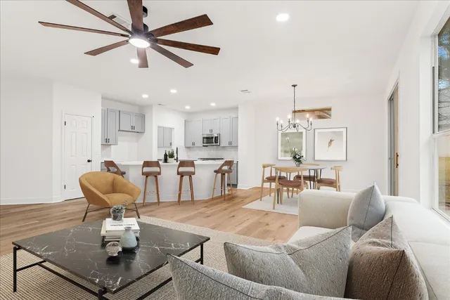 a living room with furniture and kitchen view