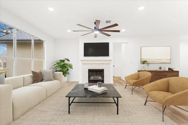 a living room with furniture a fireplace and a flat screen tv