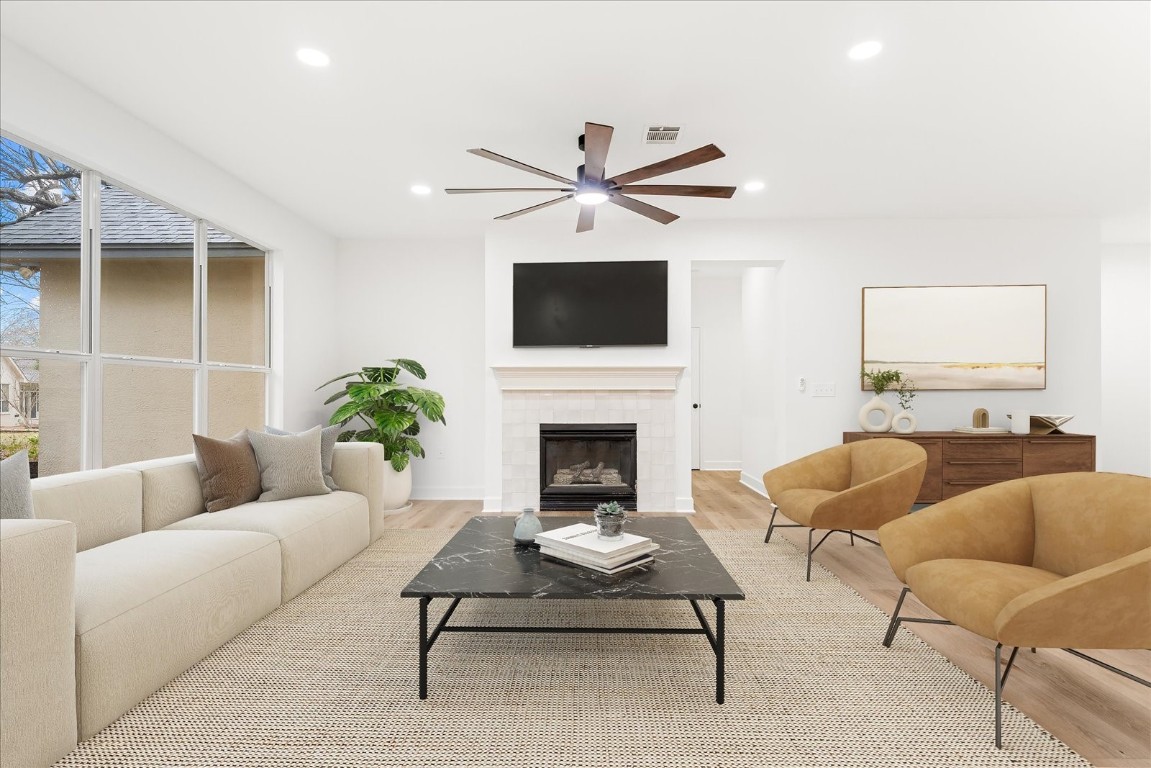 151 Dan Moody Trail Georgetown, TX 78633 - Photo 8 of 31 a living room with furniture a fireplace and a flat screen tv