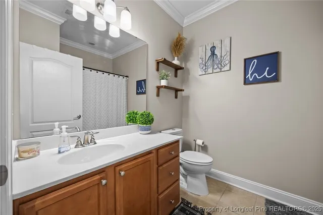 a bathroom with a granite countertop toilet sink and mirror