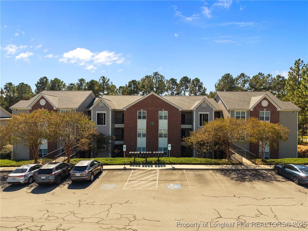 62 Gallery Drive, Unit 302 Spring Lake, NC 28390 - Photo 2 of 34 a front view of a house with yard and balcony