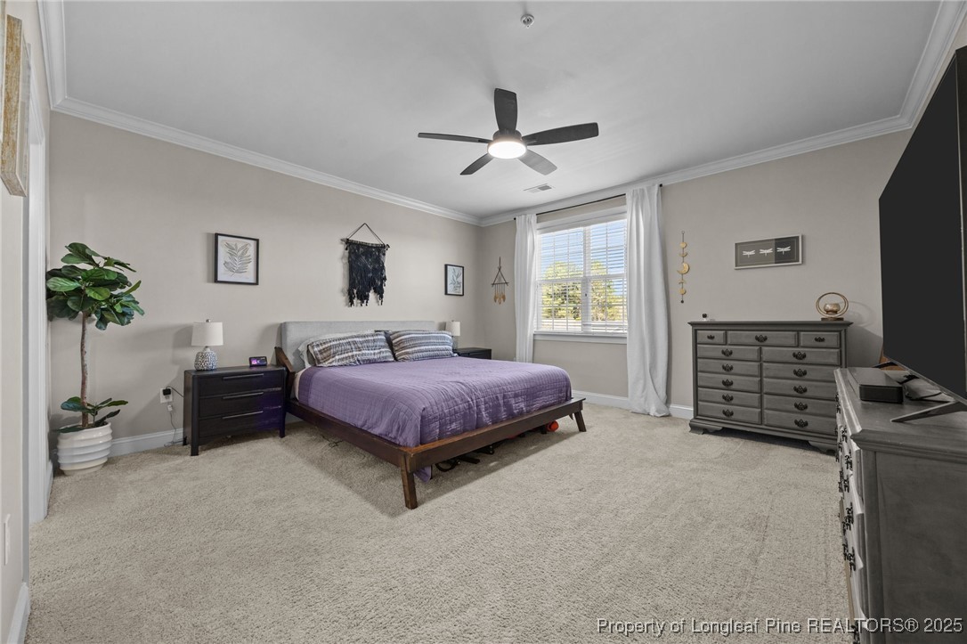 62 Gallery Drive, Unit 302 Spring Lake, NC 28390 - Photo 24 of 34 a spacious bedroom with a bed a dresser and a flat screen tv