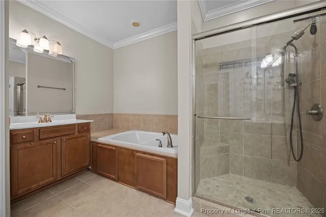 a bathroom with a tub a sink shower and mirror