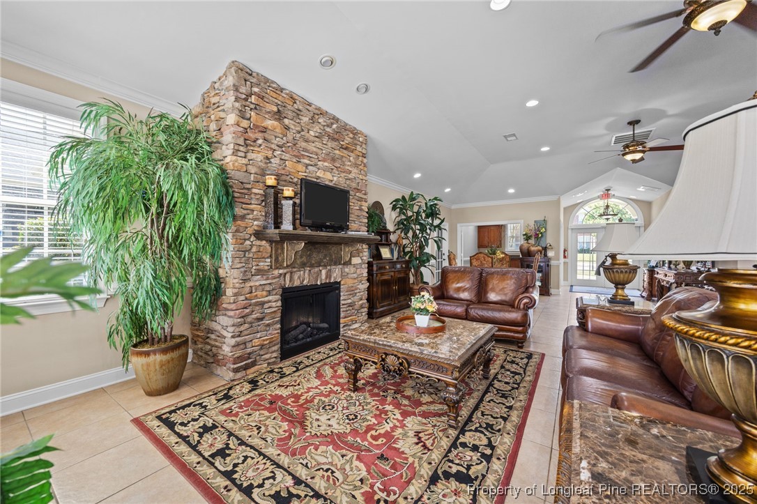 62 Gallery Drive, Unit 302 Spring Lake, NC 28390 - Photo 32 of 34 a living room with furniture a fireplace and a potted plant
