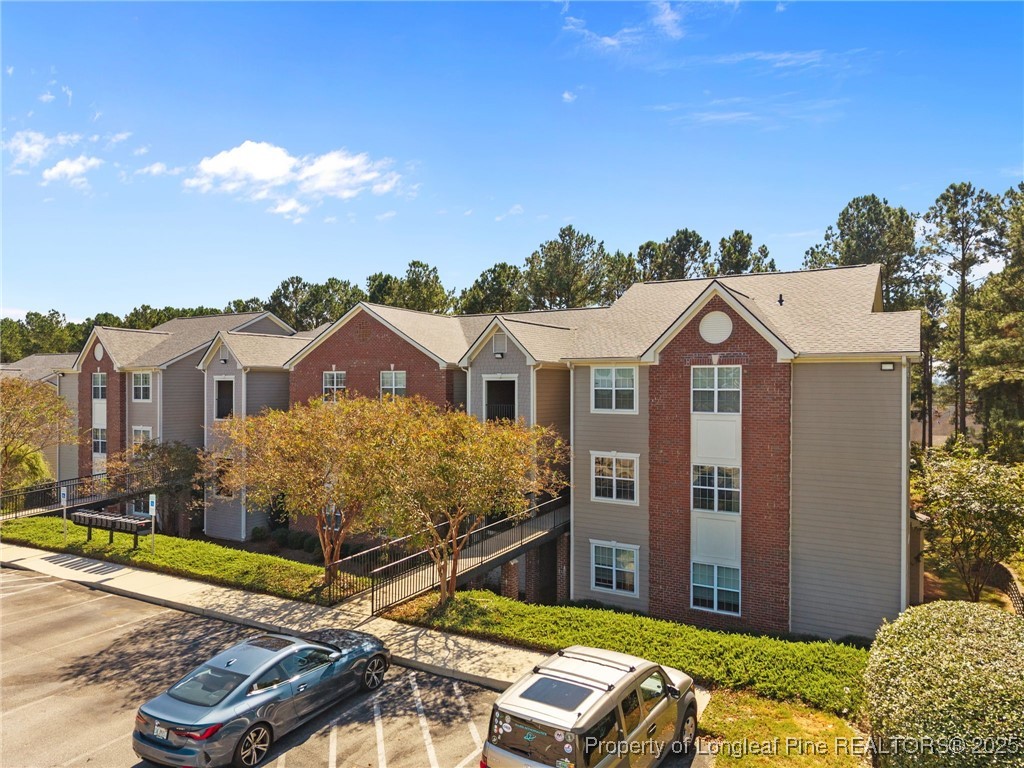 62 Gallery Drive, Unit 302 Spring Lake, NC 28390 - Photo 4 of 34 a view of a house with a small yard and potted plants