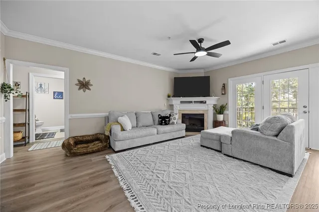 a living room with furniture a fireplace and a flat screen tv
