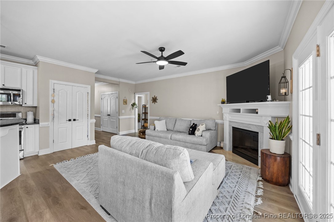 62 Gallery Drive, Unit 302 Spring Lake, NC 28390 - Photo 10 of 34 a living room with furniture a fireplace and a flat screen tv