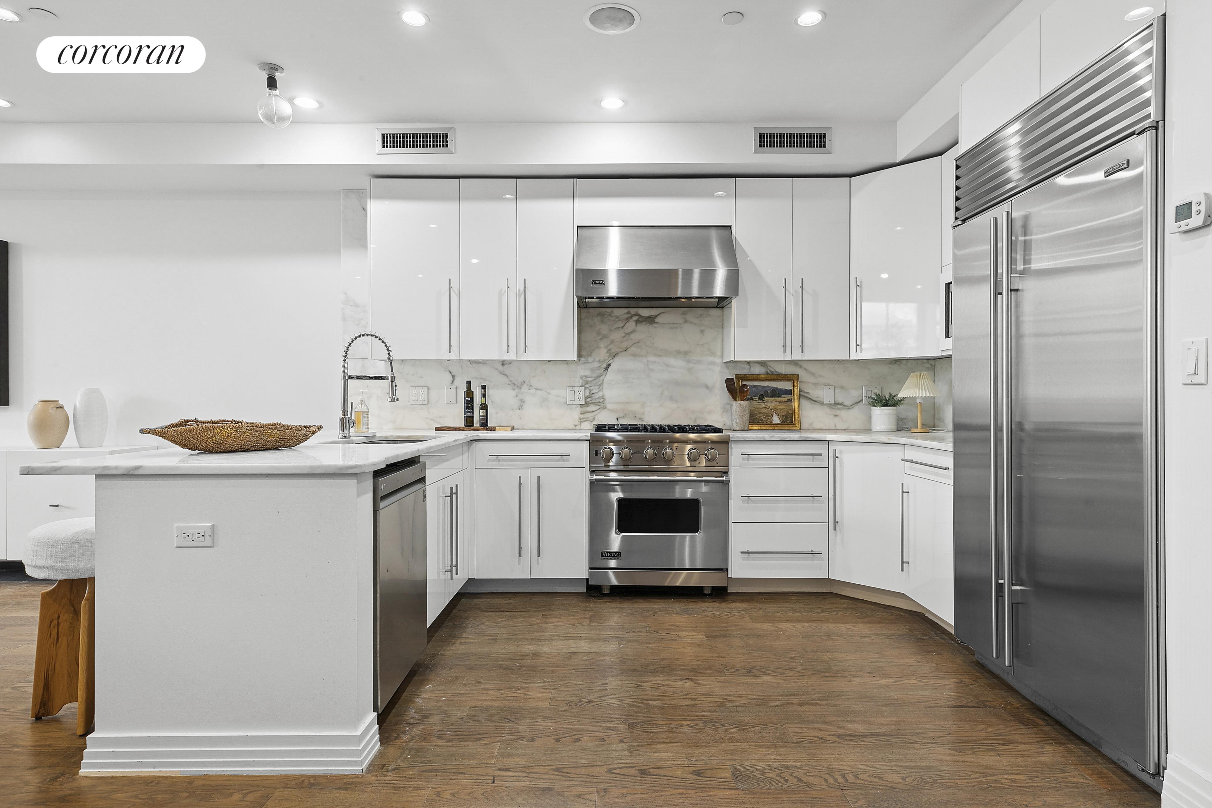 46 Lispenard Street, Unit 5E Manhattan, NY 10013 - Photo 3 of 8 a kitchen with white cabinets and white appliances