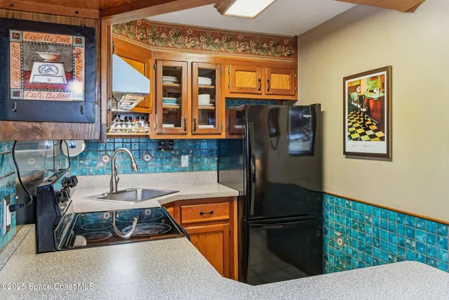 a kitchen with stainless steel appliances granite countertop a refrigerator and a stove