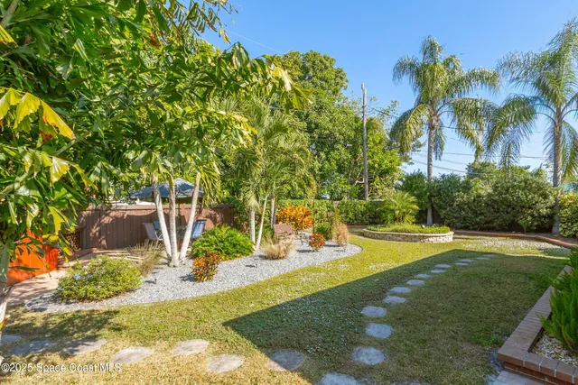 a view of a house with a yard and plants