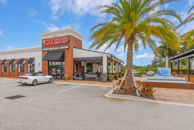a front view of a building with garden