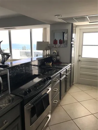 a kitchen with a stove a sink and a microwave