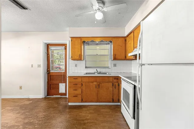a large bathroom with a granite countertop sink a mirror and shower