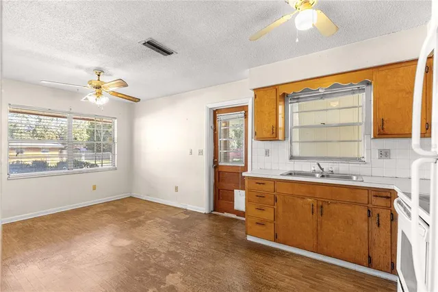 a view of a kitchen with a sink and a window