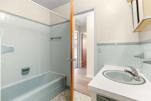 a bathroom with a sink a bathtub and a shower