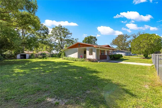 a front view of house with yard and green space